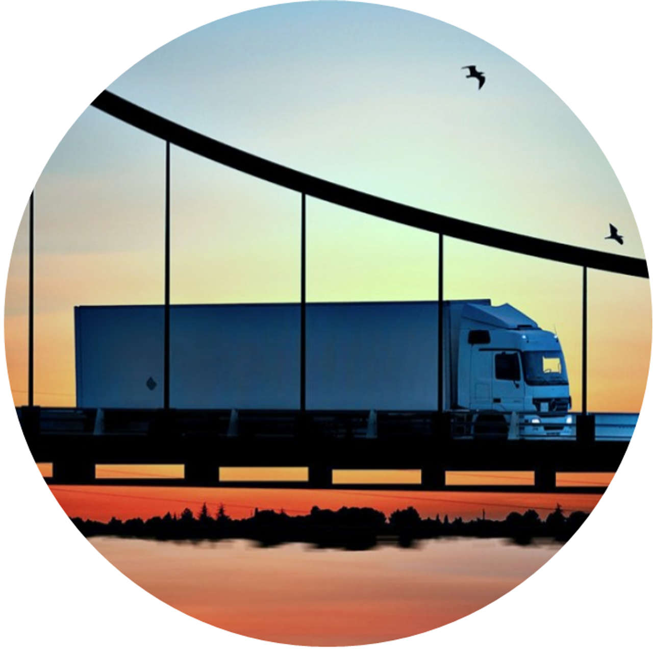 A truck on a bridge, with a sunset in the background